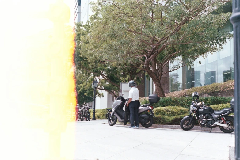 a pair of motorcycles with two men in the background