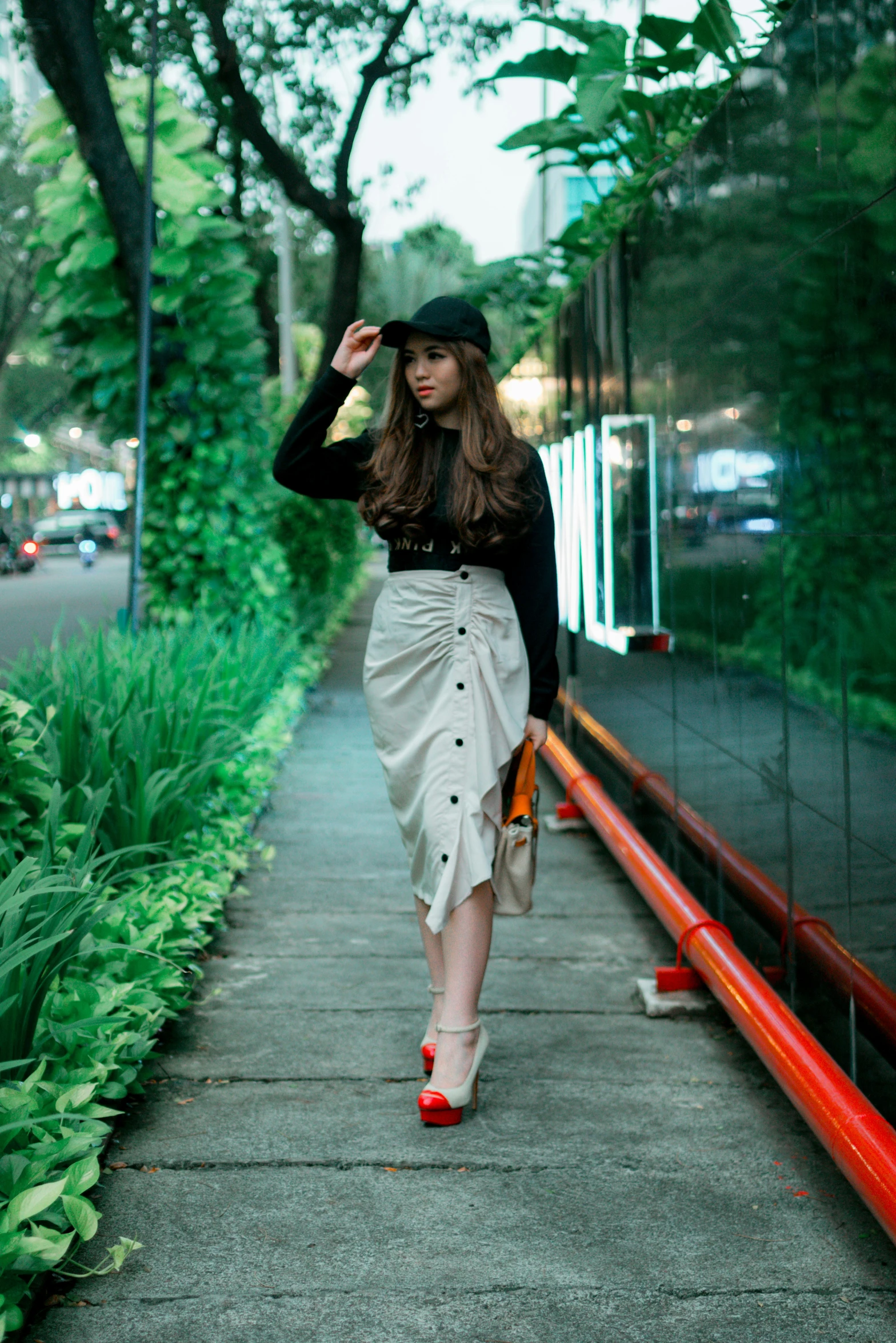 a beautiful woman in red shoes walking down the street