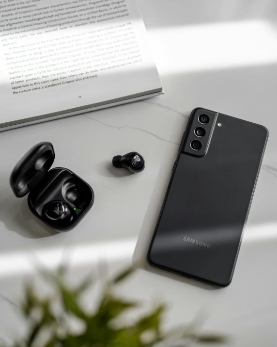 an image of earbuds and cellphone on a table