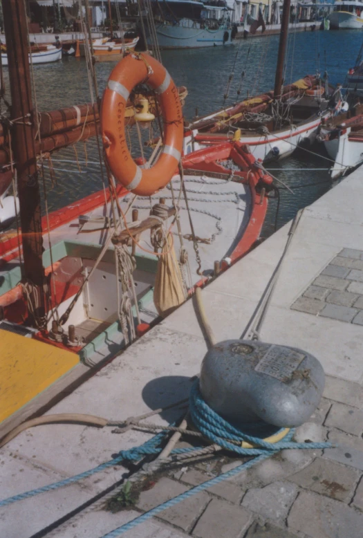 a ship moored at the dock with a life ring sitting on top
