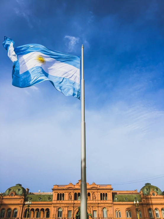 an old building with a flag on top in the city