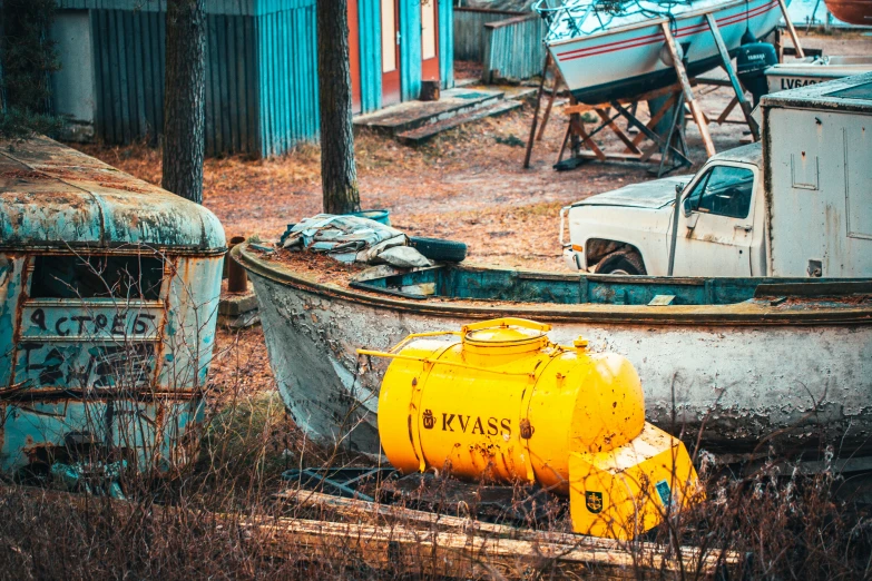 an old run down boat and two yellow gas containers