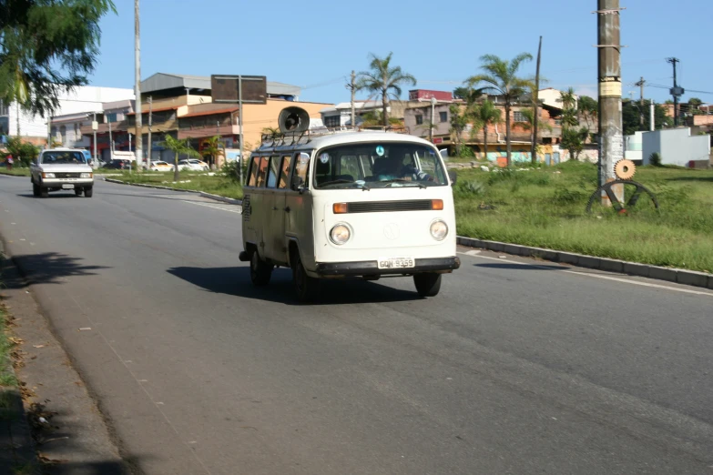 a vintage vw bus driving down a street