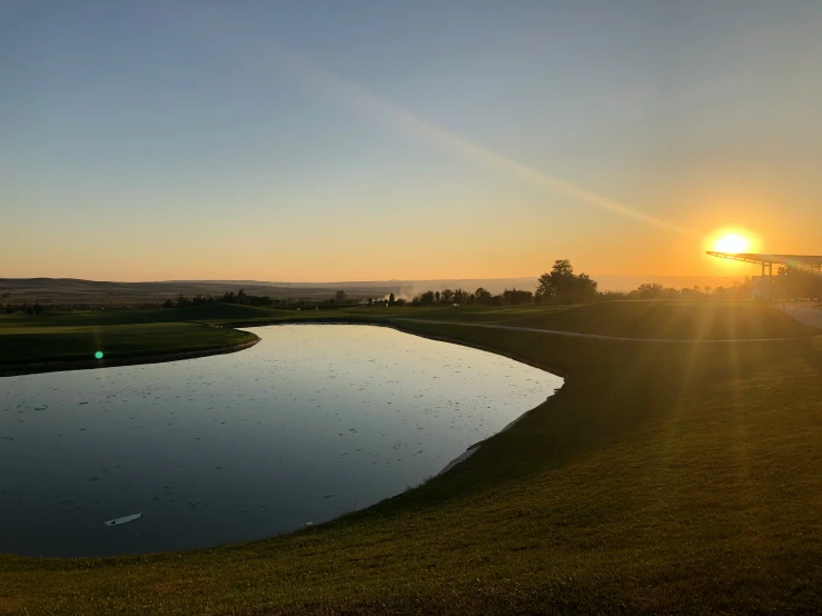 a view of a large body of water at sunset