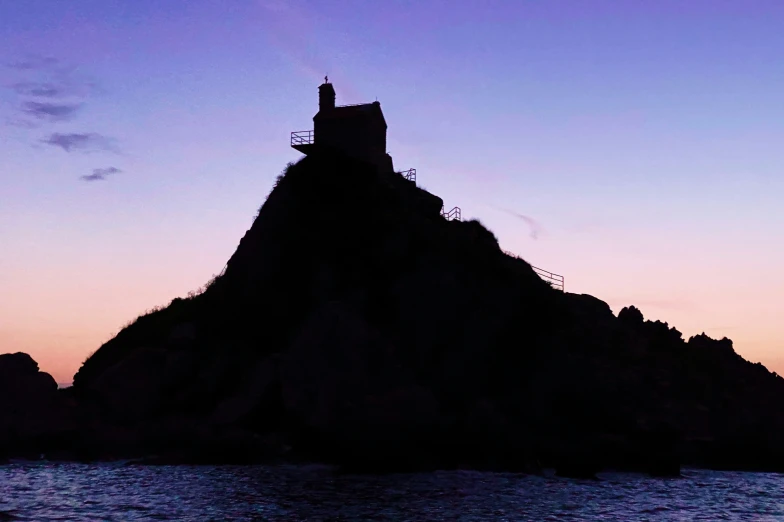 a tower of a cliff is illuminated by the sun