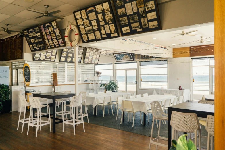 a restaurant has white tables with white chairs