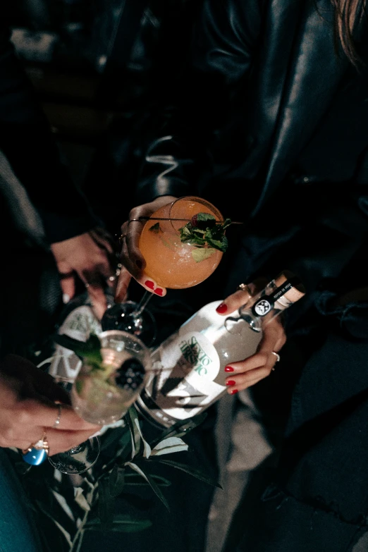 a man that is holding two glasses with some food on them