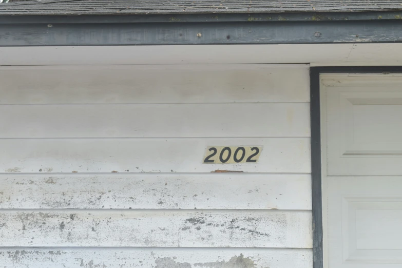 the number 2012 is painted on the wall next to a house