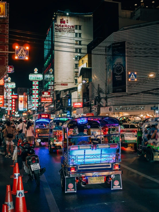 many vehicles on city street at night near some buildings