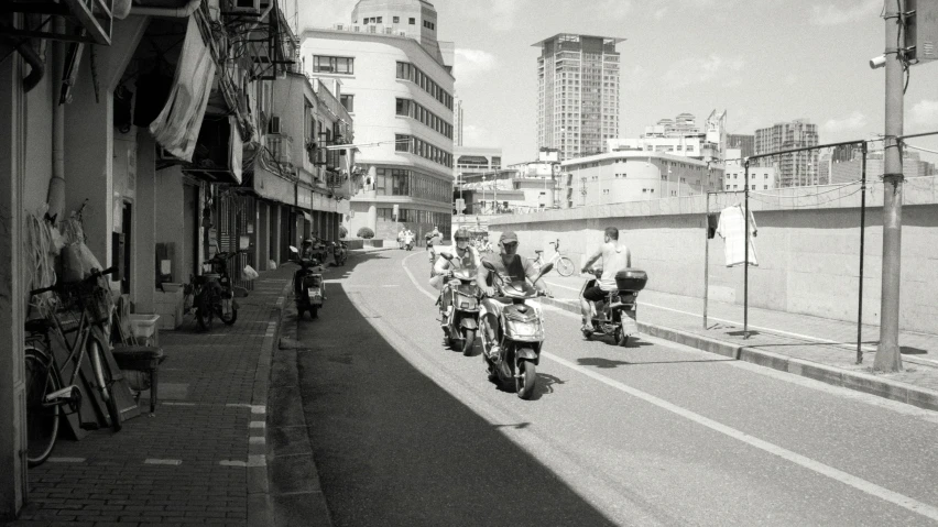 motorcyclists and motorcycles are riding in a line down a road