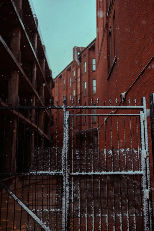 a gated area with a brick building and several windows