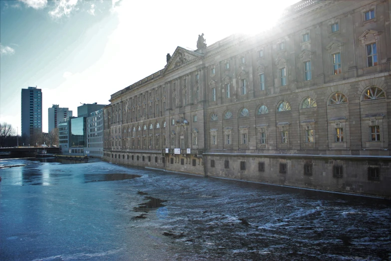 the sun shines on a building in an urban setting