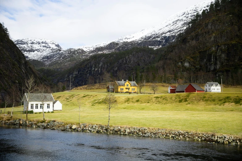 a small house is sitting alone near the river