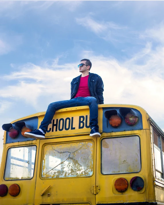 a person sitting on the back of a school bus