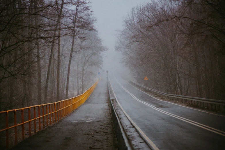 there is a path on the side of the road in the rain