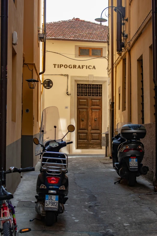 a motor scooter sitting in front of an apartment