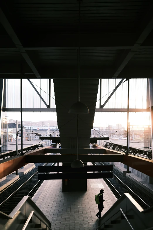 this is a view from inside the building looking out on a person walking