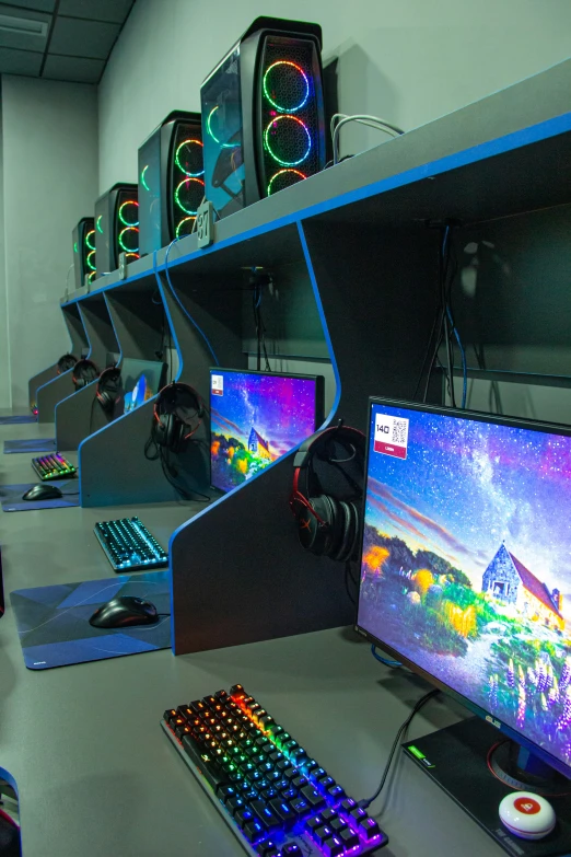 several computer screens and keyboards on a table