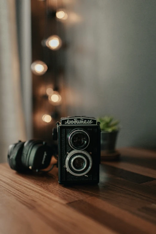 a camera with two different lens sizes sitting on a table