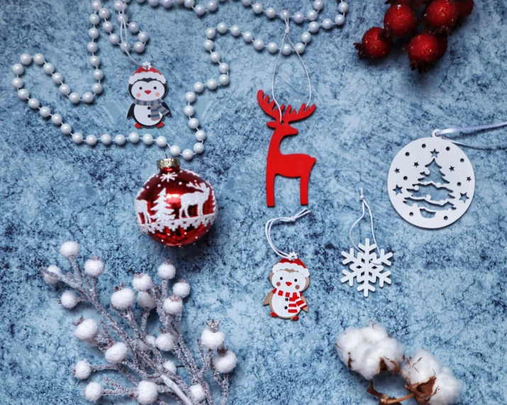 christmas ornaments are displayed on a surface among decorations