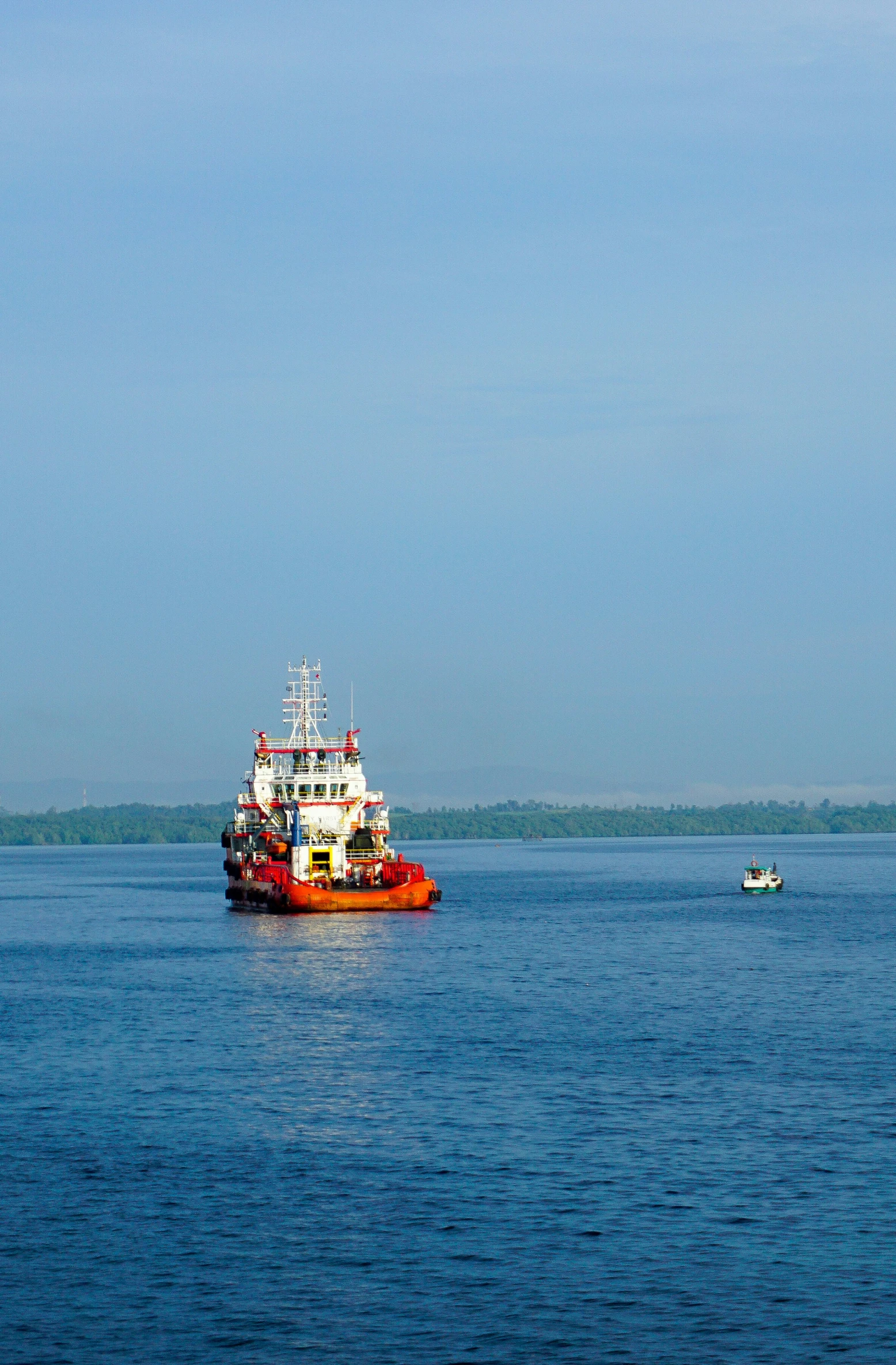 the large boat is in the middle of the calm blue water