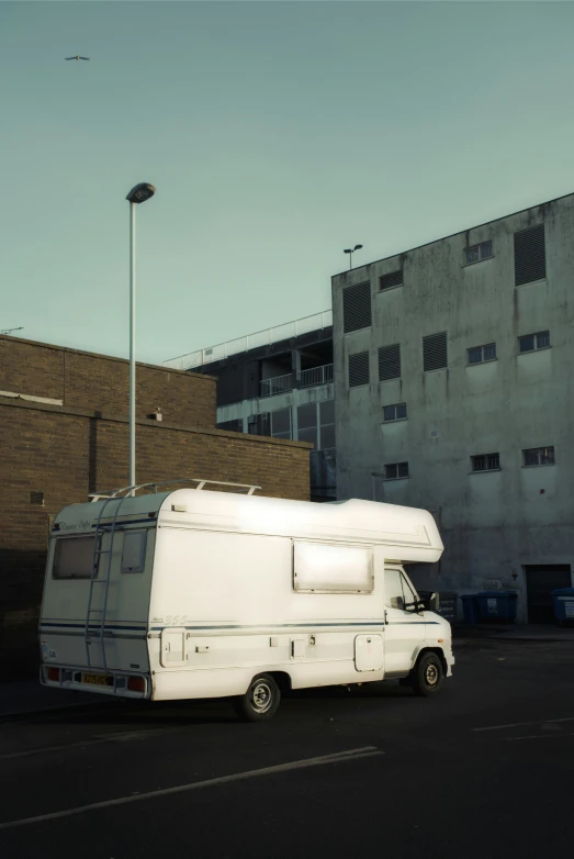 an old recreational vehicle parked in a parking lot