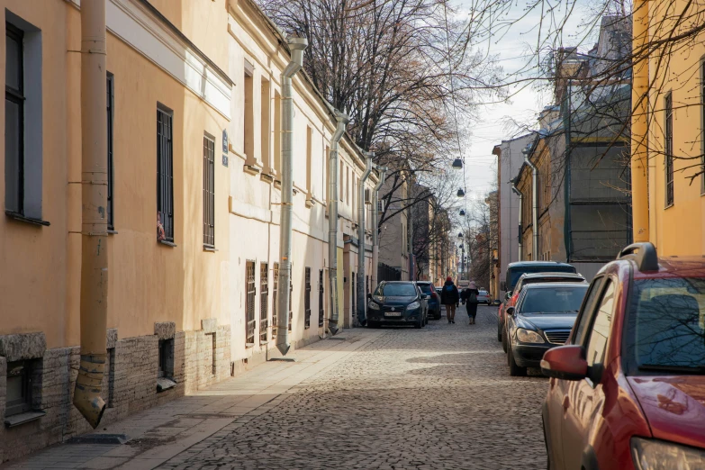 there is a street that has many cars parked on it