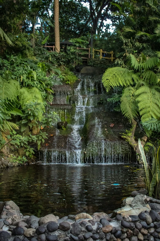 a waterfall at the bottom of a rock garden