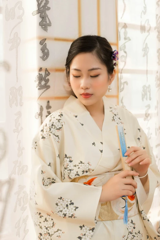 a young lady holding a toothbrush and comb