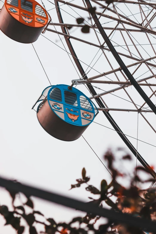 the view of a ferris wheel in the sky through nches