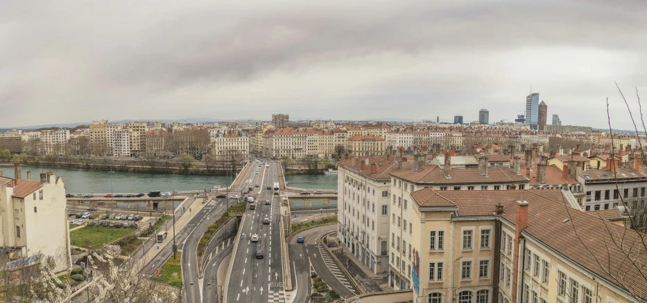 an aerial view of a city street next to river