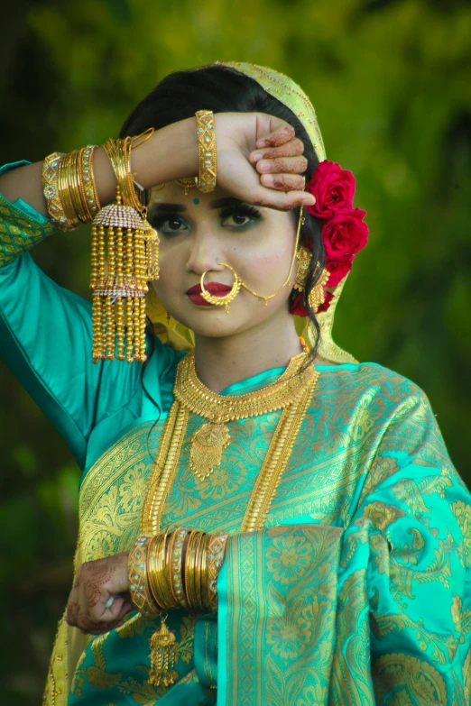 a woman is dressed in ethnic attire and jewelry