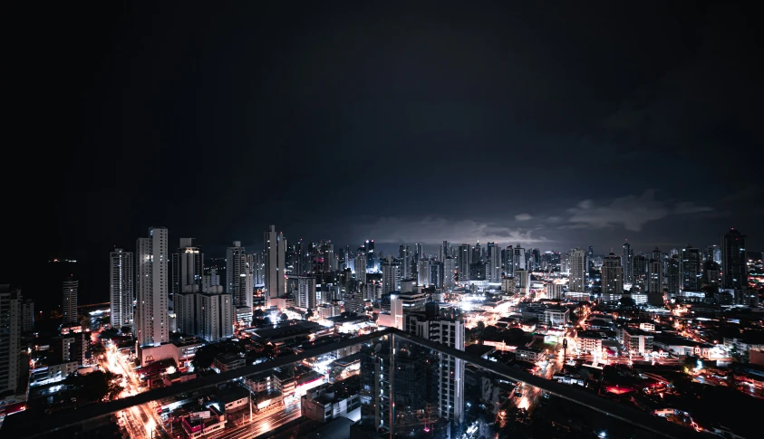 an aerial view of city at night with the lights on