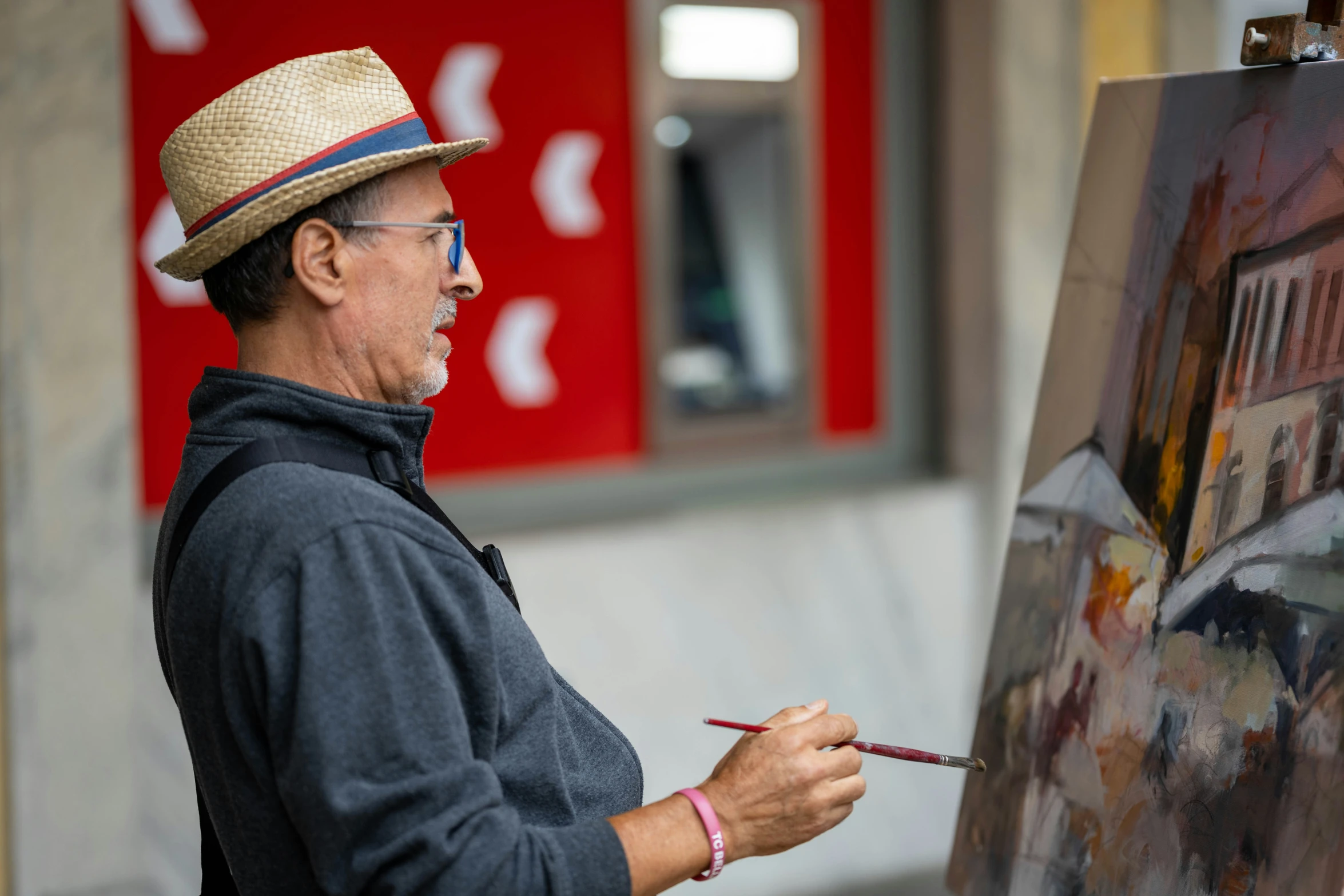 a man with a straw hat on painting