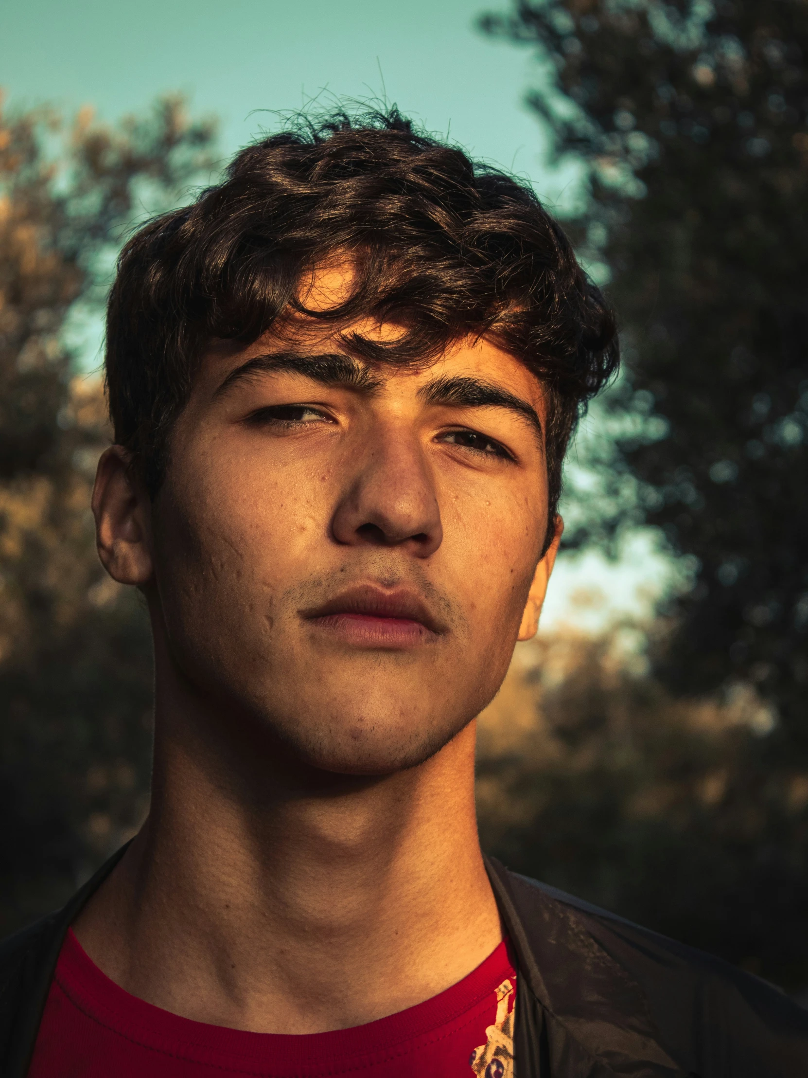 a close up of a man with a necklace on