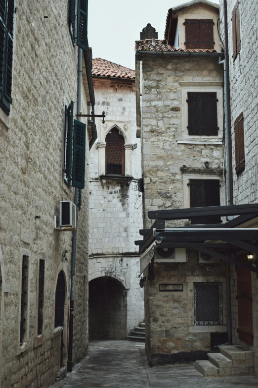 a stone street with many windows in it