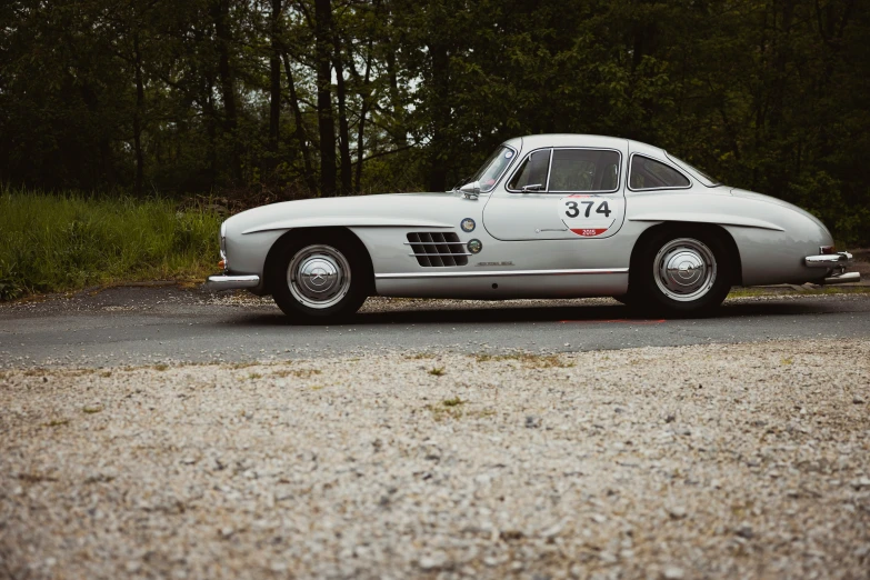 an antique car parked by the side of the road