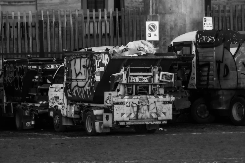 garbage trucks are parked in front of a large building