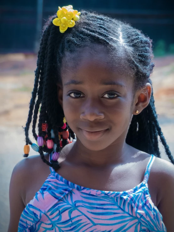 a little girl with many twists in her hair