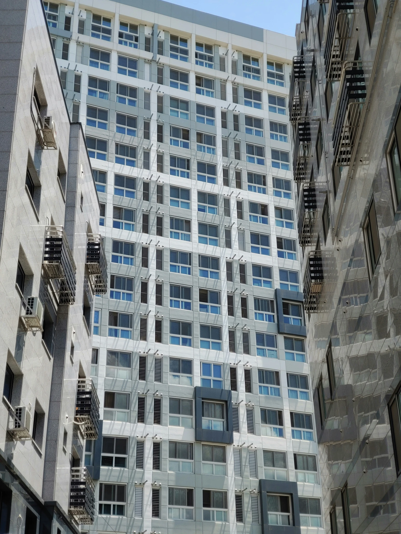 looking up at a modern looking building with windows