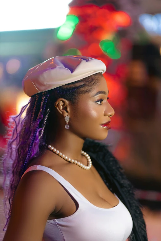 a woman with an afro - colored hair and pearl necklace is looking to her right