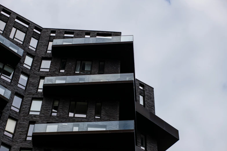 building with multiple windows on a cloudy day