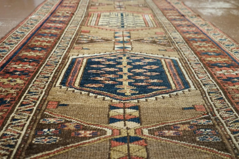 a multi colored persian carpet with lots of small diamonds on the edges