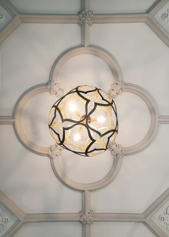 a chandelier is lit in a circle and has three lights on each side