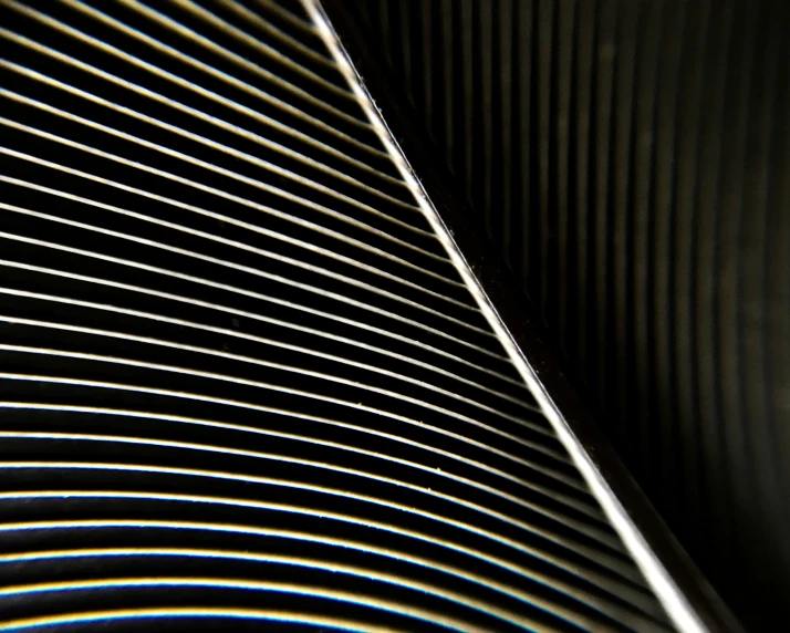 a close - up po of lines and curves in metallic paper