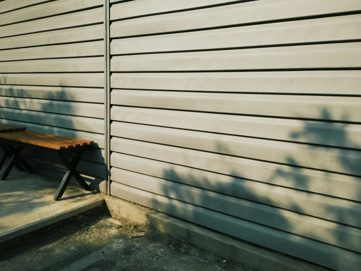 the shadow of a tree casts on a bench