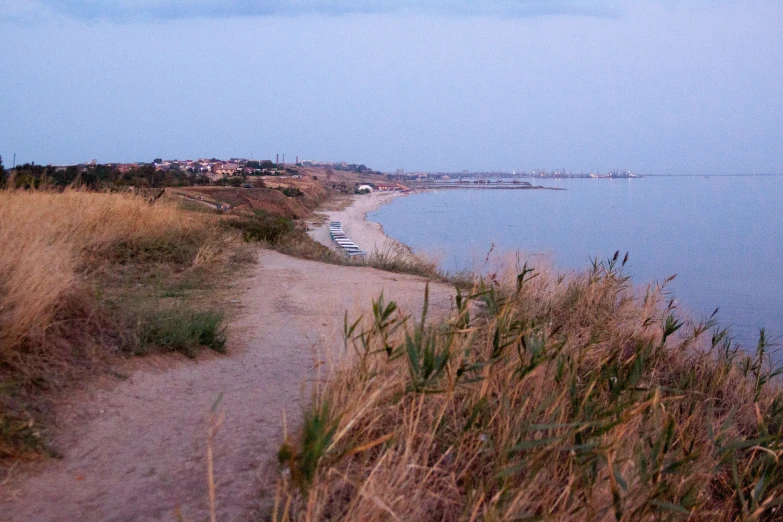 a walkway leading to the ocean at dusk