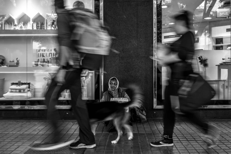 some people and a dog sitting in front of a store