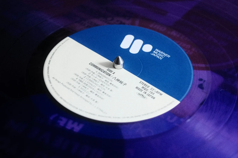 a blue and white record on display with an empty disc