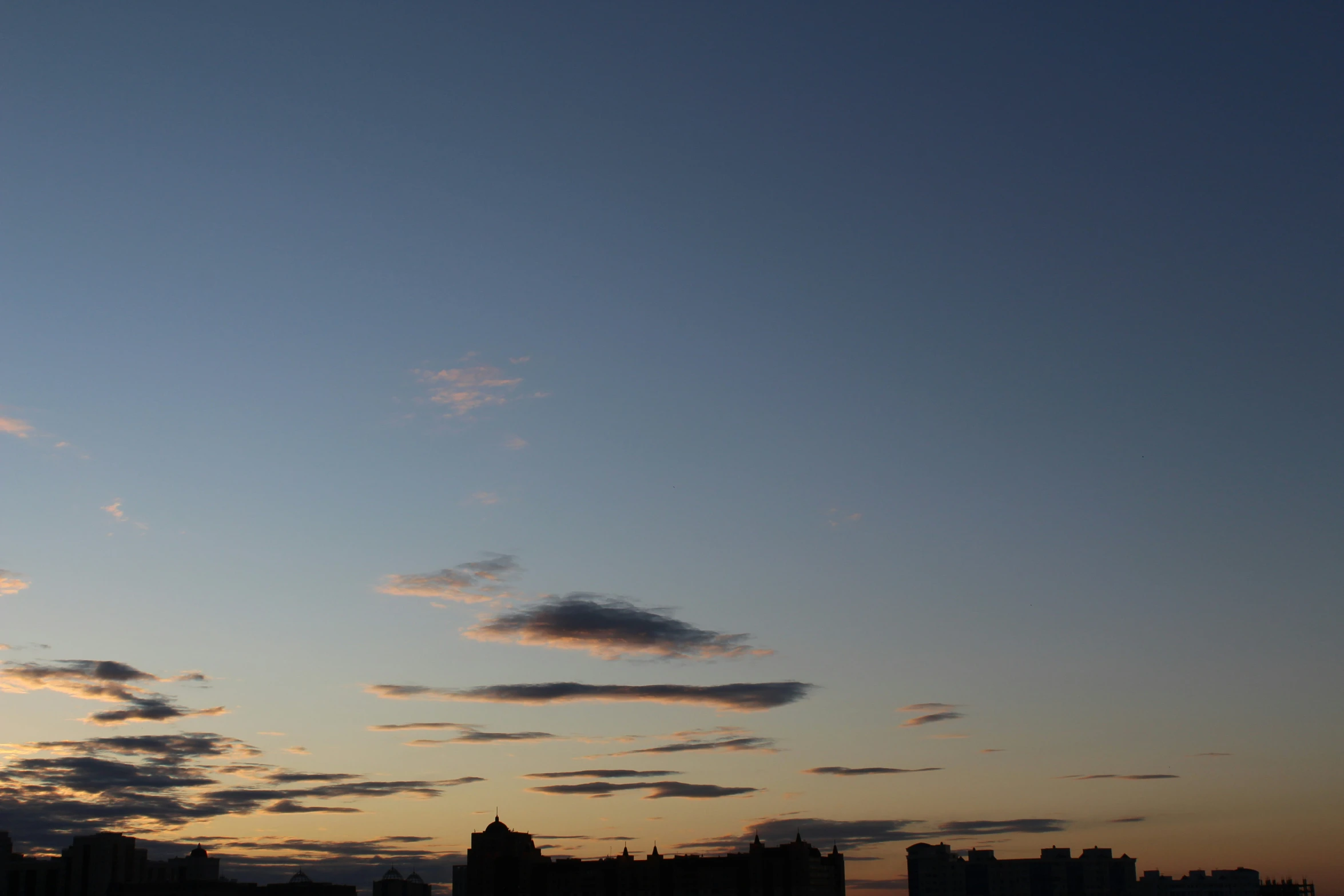 the skyline is lit up by an orange and yellow sky